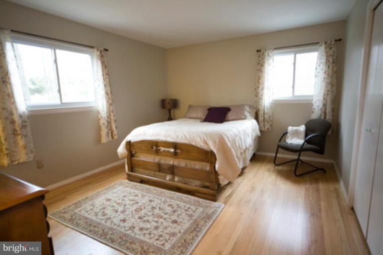 6512 Darwin Road Laurel, MD 20707 - Photo 10 of 22 a bedroom with a bed and wooden floor