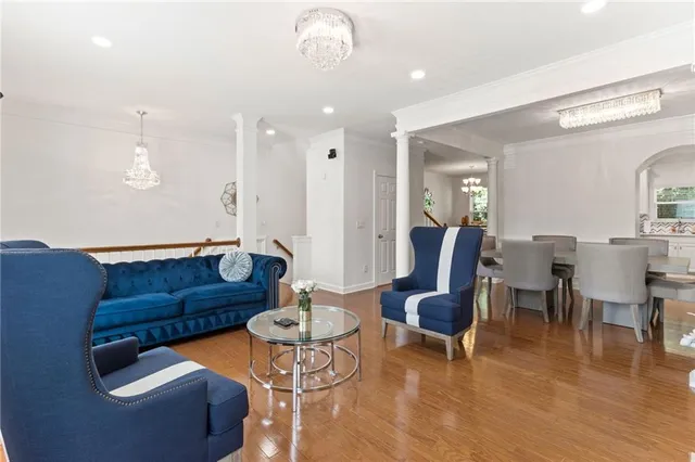 a living room with furniture and wooden floor