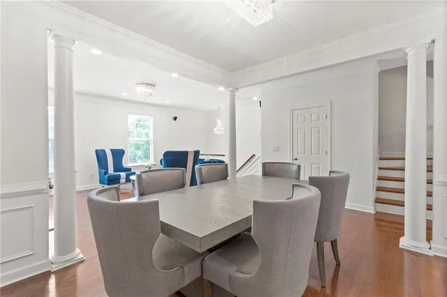 a view of a dining room with furniture and wooden floor