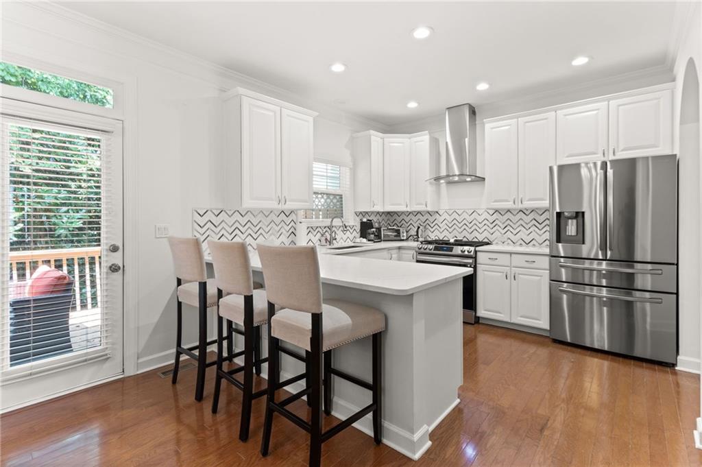 2086 Cobblestone Circle Northeast Atlanta, GA 30319 - Photo 15 of 34 a kitchen with stainless steel appliances a table chairs refrigerator microwave and cabinets