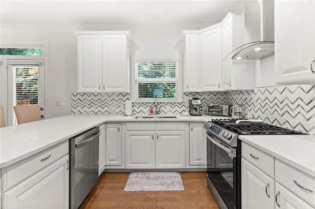 a kitchen with a sink stove and cabinets