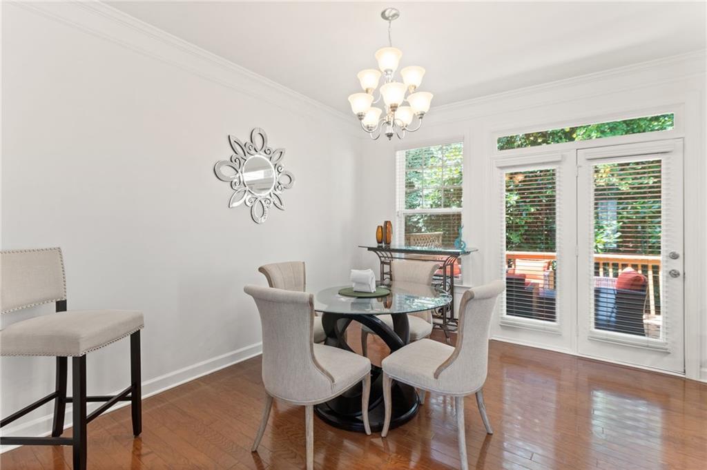 2086 Cobblestone Circle Northeast Atlanta, GA 30319 - Photo 21 of 34 a view of a dining room with furniture a chandelier and wooden floor