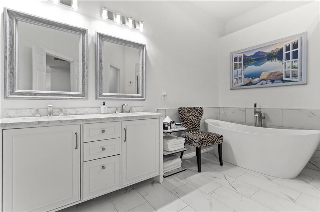 2086 Cobblestone Circle Northeast Atlanta, GA 30319 - Photo 26 of 34 a bathroom with a bathtub and a sink