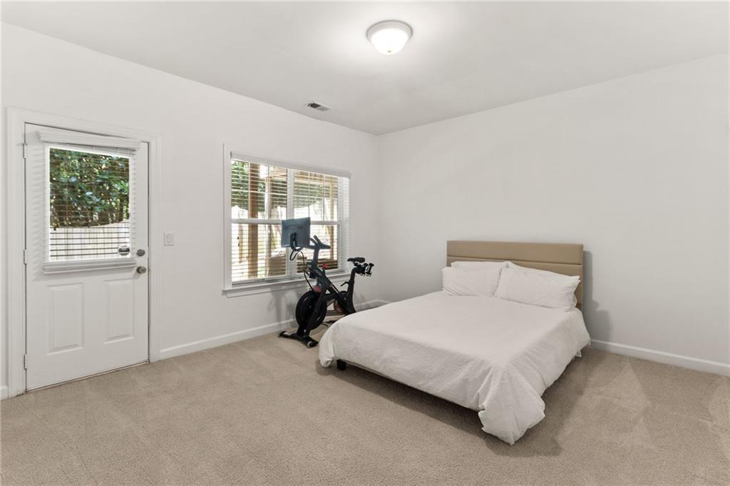 2086 Cobblestone Circle Northeast Atlanta, GA 30319 - Photo 28 of 34 a bedroom with a bed and a table