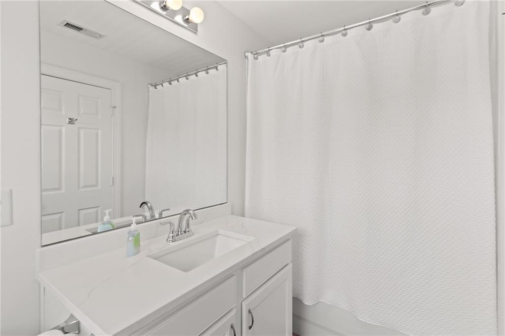 2086 Cobblestone Circle Northeast Atlanta, GA 30319 - Photo 32 of 34 a bathroom with a sink and a mirror
