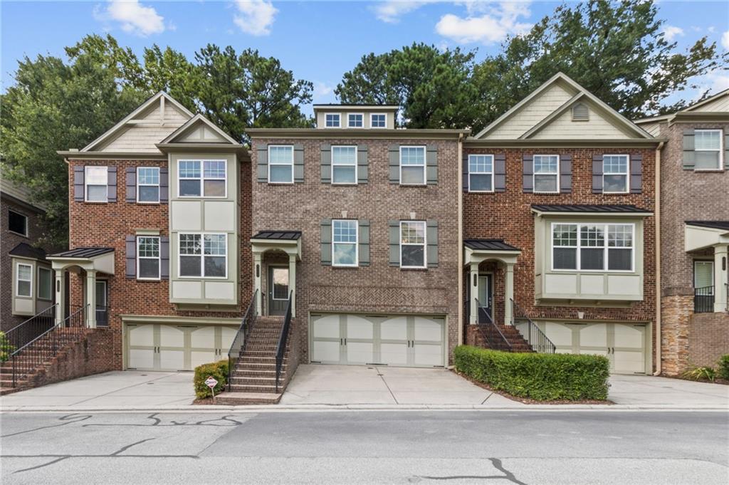2086 Cobblestone Circle Northeast Atlanta, GA 30319 - Photo 4 of 34 a front view of a house with a garden