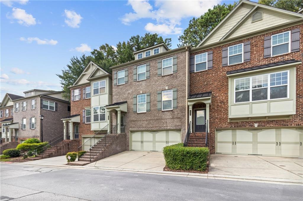 2086 Cobblestone Circle Northeast Atlanta, GA 30319 - Photo 5 of 34 a view of a brick house with many windows