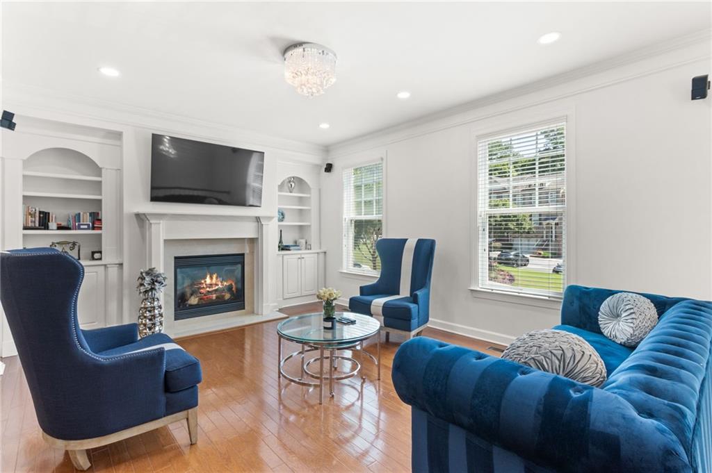 2086 Cobblestone Circle Northeast Atlanta, GA 30319 - Photo 8 of 34 a living room with furniture a flat screen tv and a fireplace