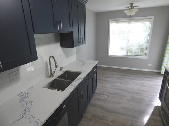 a kitchen with a sink stove and cabinets