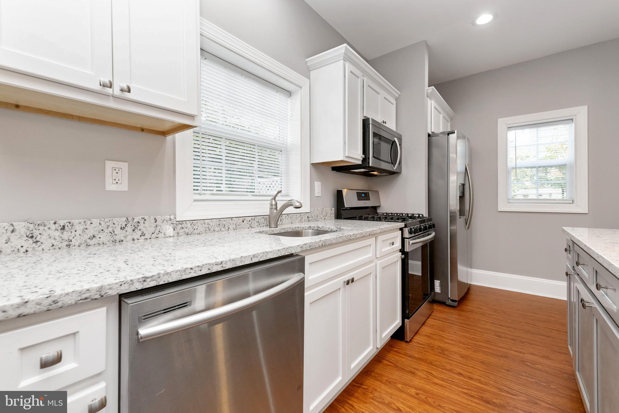 2505 Hammonds Ferry Road Baltimore, MD 21227 - Photo 12 of 36 a kitchen with stainless steel appliances granite countertop a sink stove and refrigerator