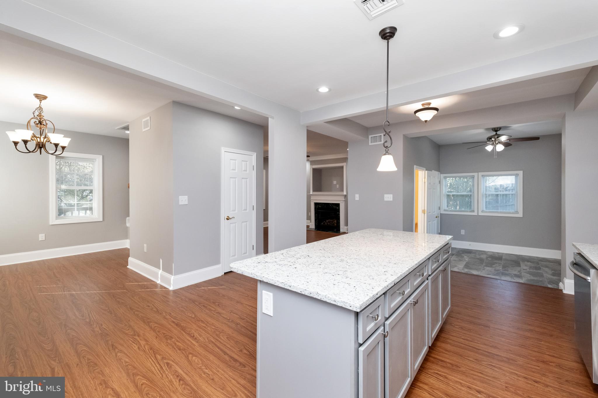 2505 Hammonds Ferry Road Baltimore, MD 21227 - Photo 13 of 36 a open kitchen with a refrigerator a sink dishwasher and wooden floor