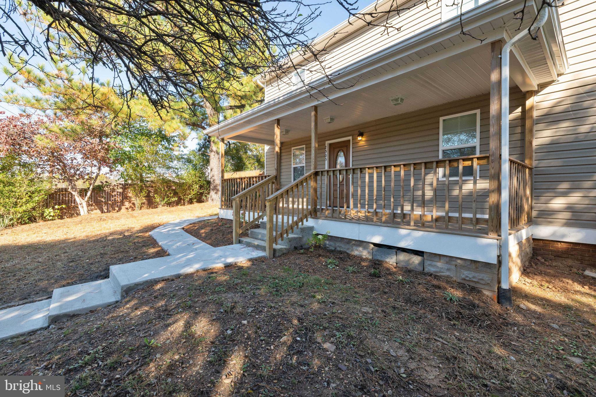 2505 Hammonds Ferry Road Baltimore, MD 21227 - Photo 3 of 36 a view of yard with wooden fence and a large tree
