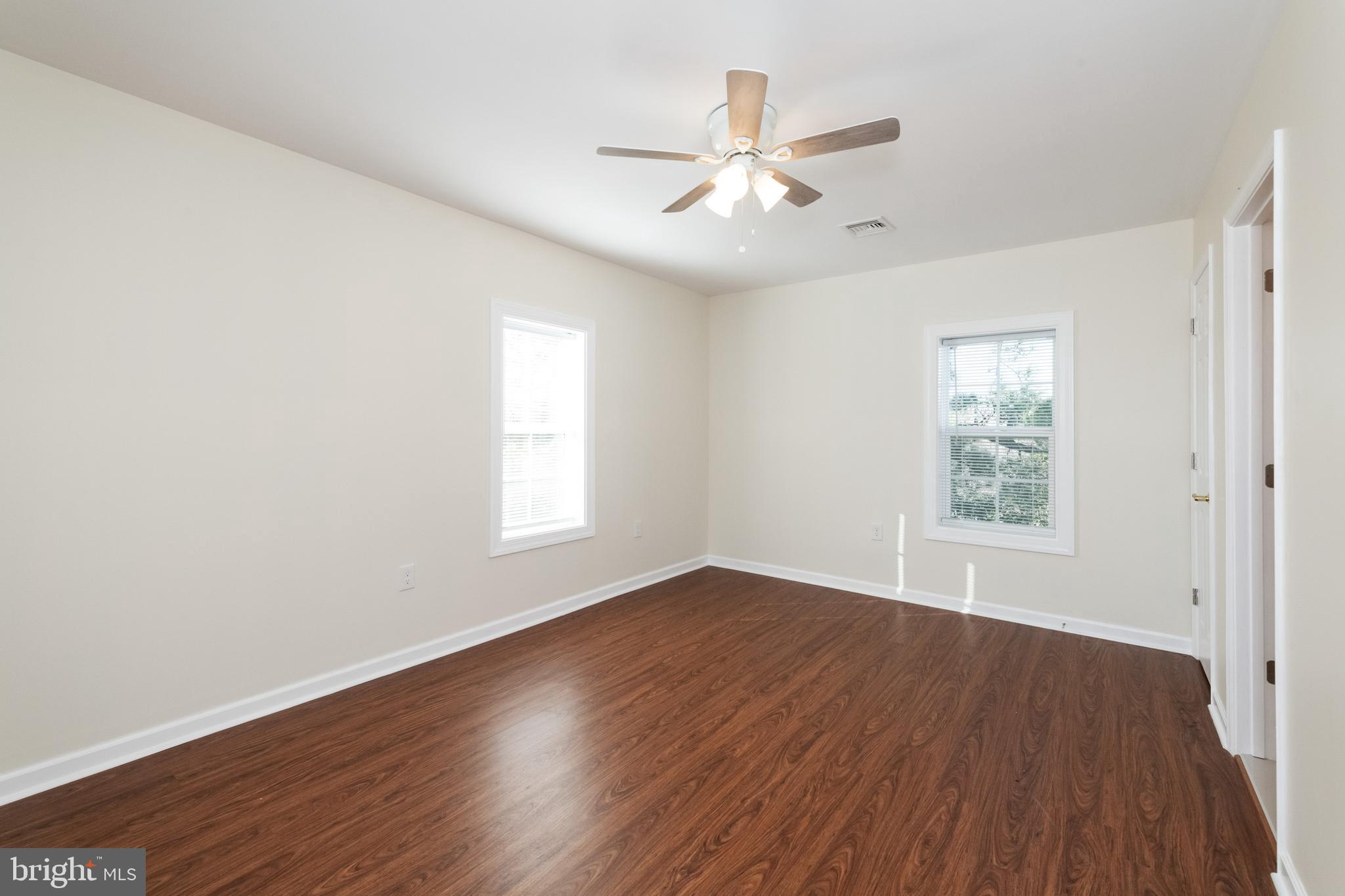 2505 Hammonds Ferry Road Baltimore, MD 21227 - Photo 22 of 36 a view of an empty room with wooden floor and a window