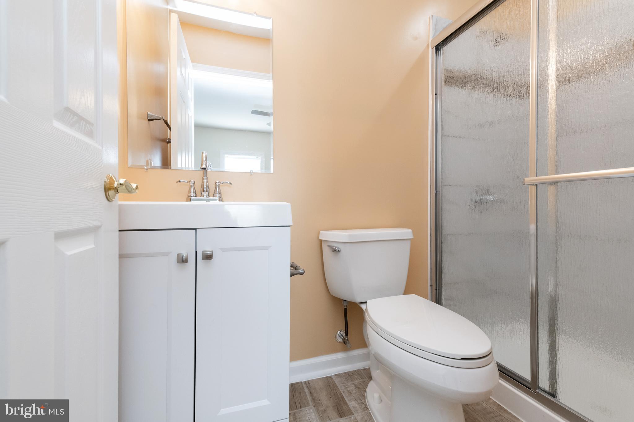2505 Hammonds Ferry Road Baltimore, MD 21227 - Photo 24 of 36 a bathroom with a toilet a sink and a mirror