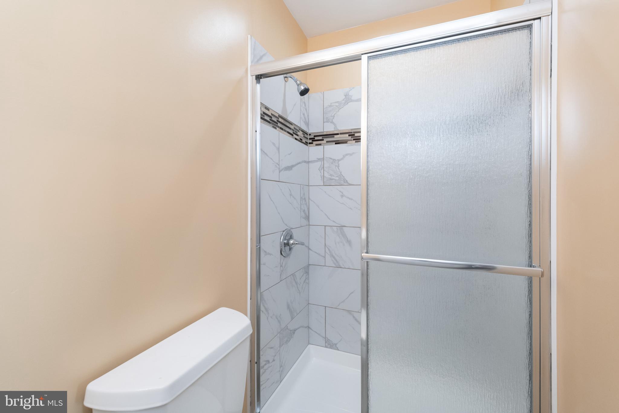 2505 Hammonds Ferry Road Baltimore, MD 21227 - Photo 25 of 36 a bathroom with a shower and a toilet