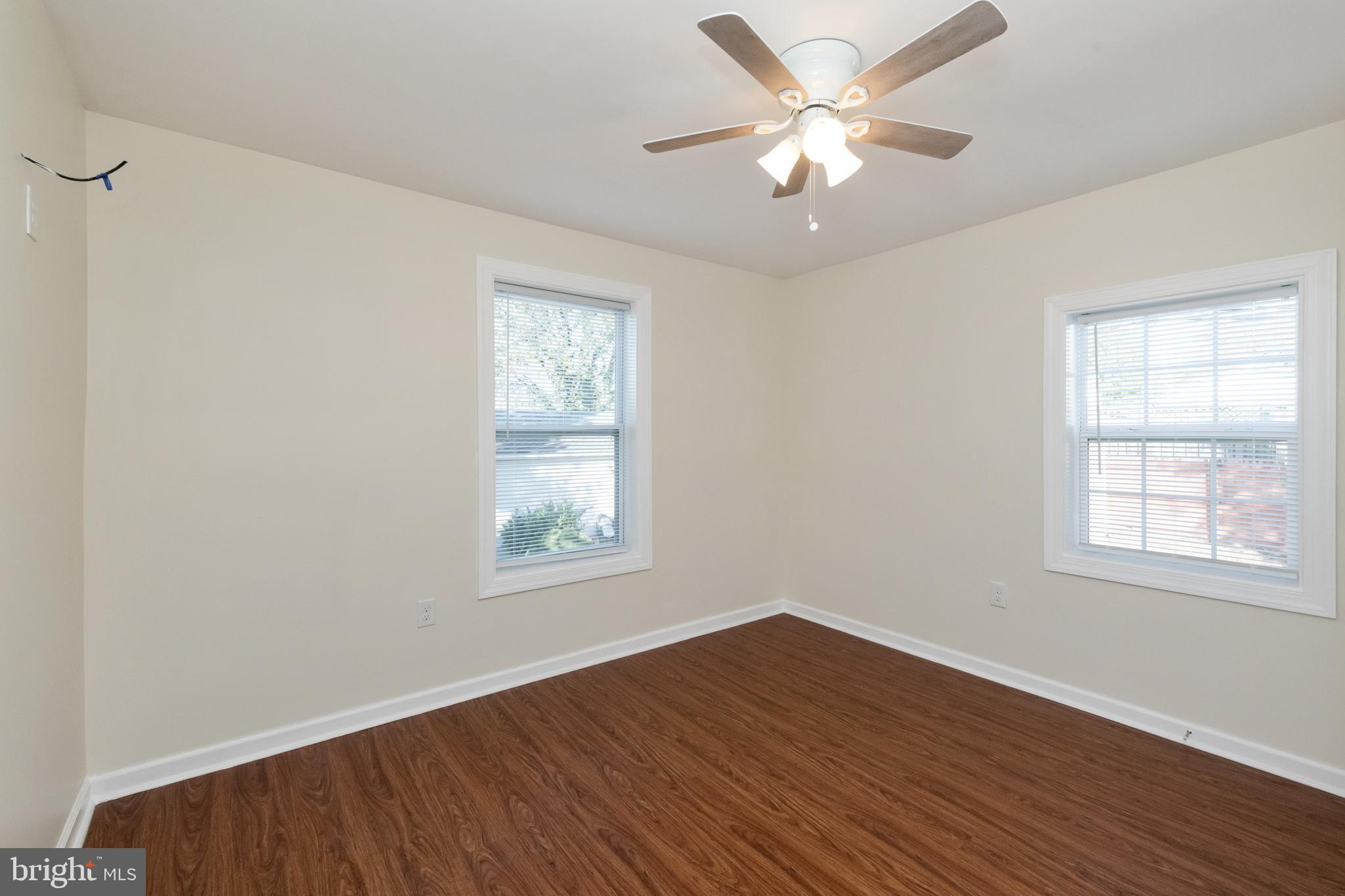 2505 Hammonds Ferry Road Baltimore, MD 21227 - Photo 26 of 36 an empty room with wooden floor and windows