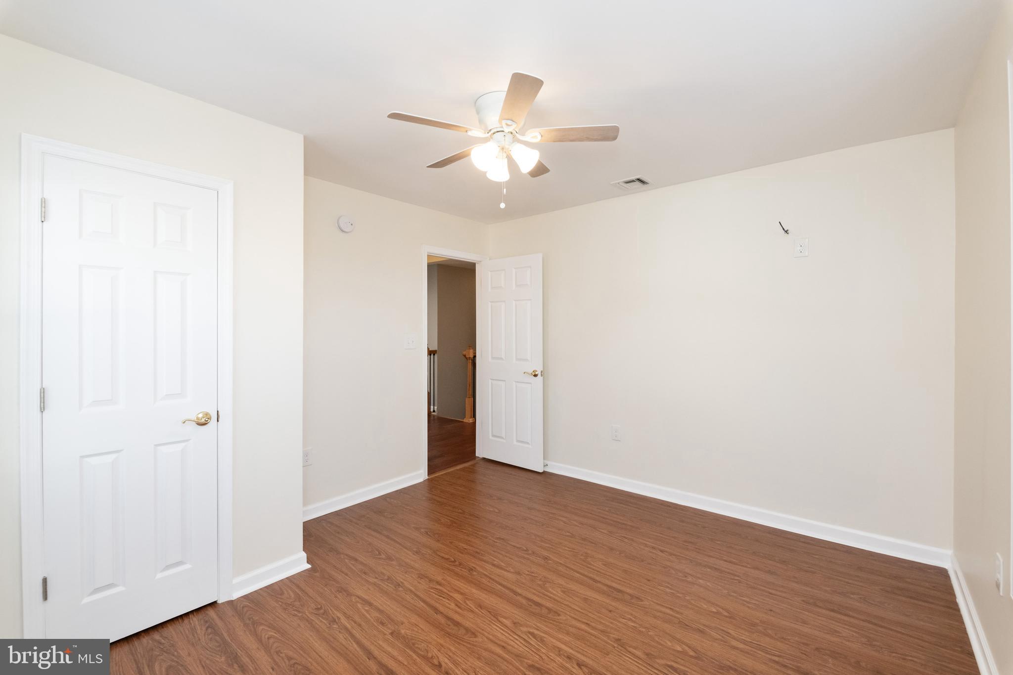 2505 Hammonds Ferry Road Baltimore, MD 21227 - Photo 27 of 36 a view of an empty room with wooden floor