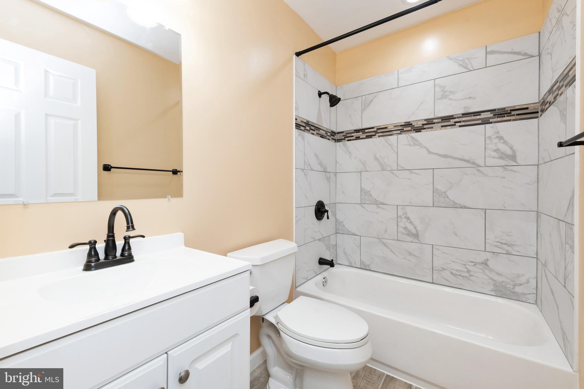 2505 Hammonds Ferry Road Baltimore, MD 21227 - Photo 28 of 36 a bathroom with a sink mirror toilet and bathtub
