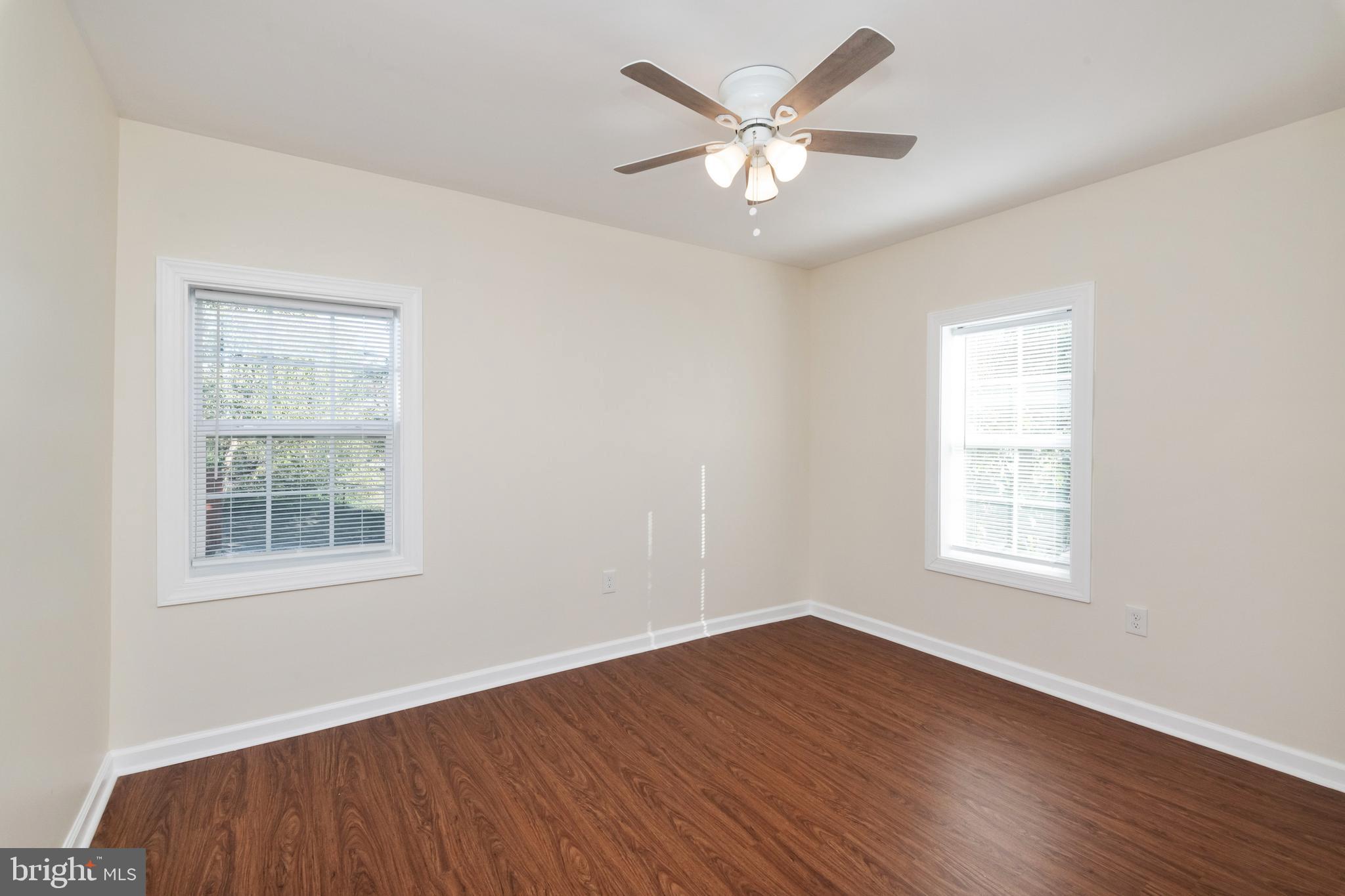 2505 Hammonds Ferry Road Baltimore, MD 21227 - Photo 29 of 36 an empty room with wooden floor and windows