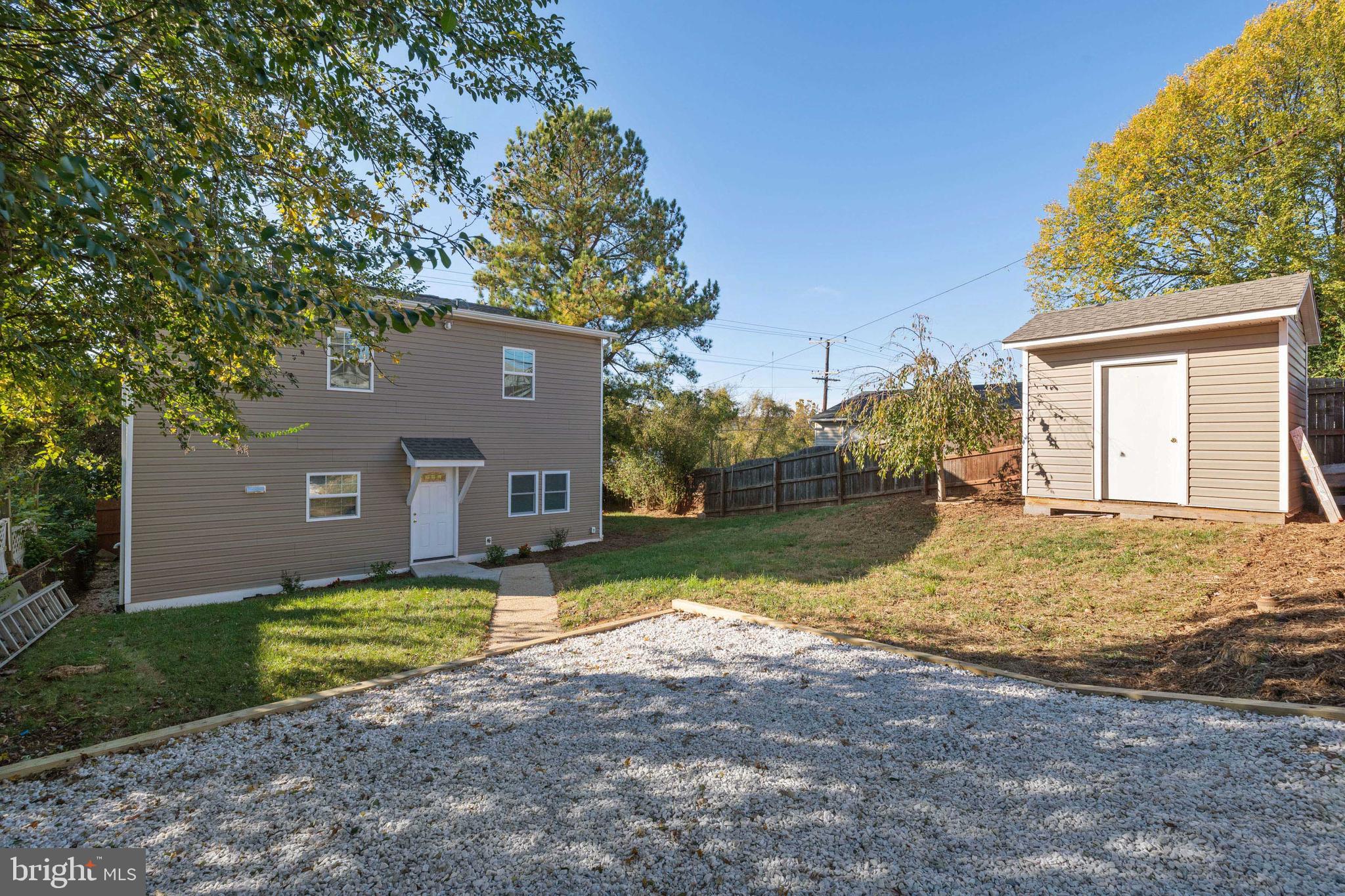 2505 Hammonds Ferry Road Baltimore, MD 21227 - Photo 35 of 36 a view of a house with a yard and a large tree