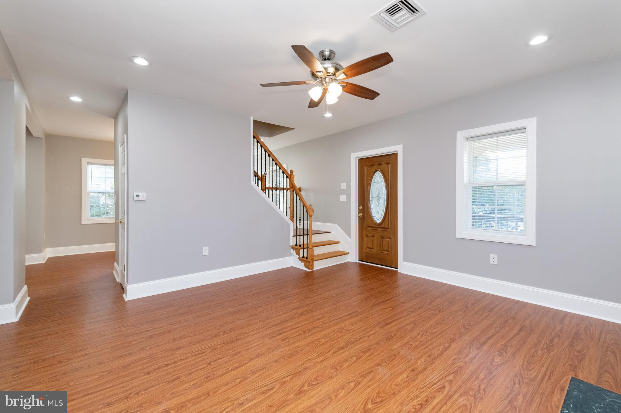 2505 Hammonds Ferry Road Baltimore, MD 21227 - Photo 6 of 36 a view of an empty room with wooden floor and a window