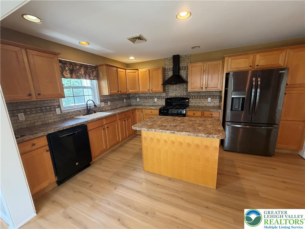 4157 Walter Road Bethlehem, PA 18020 - Photo 12 of 36 A well-equipped kitchen features a central island, ample cabinetry, and sleek appliances.