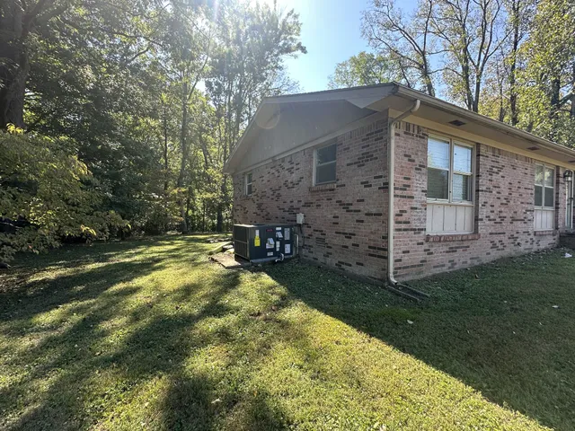 a view of a house with backyard and porch