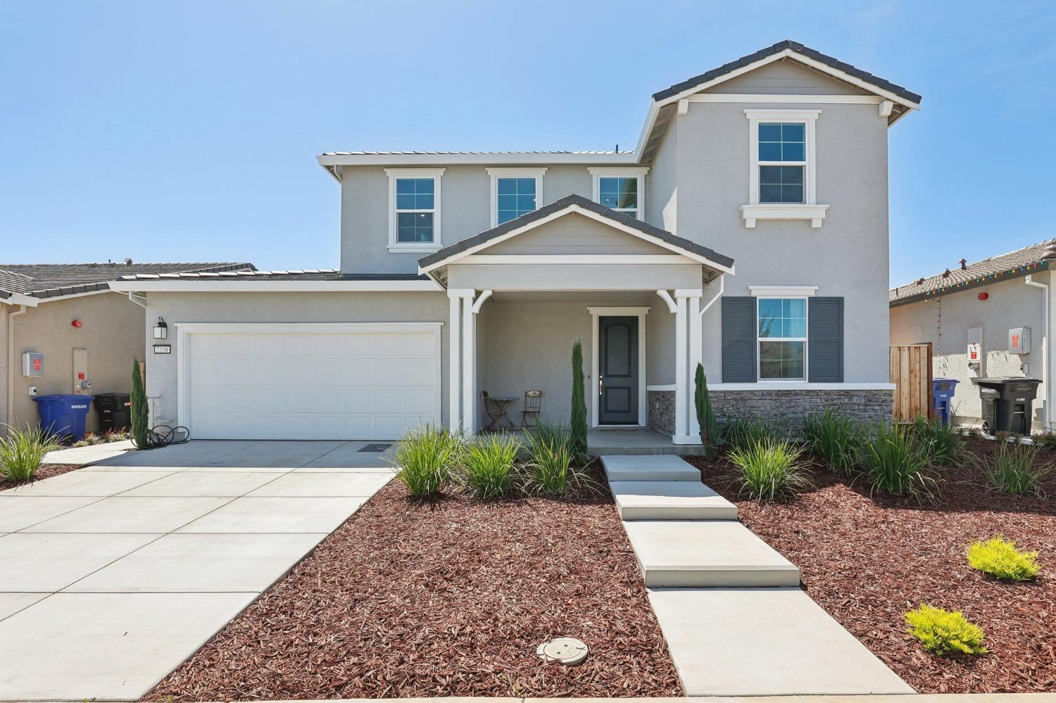 2200 Stagecoach Road Patterson, CA 95363 - Photo 1 of 35 a front view of a house with a yard and potted plants