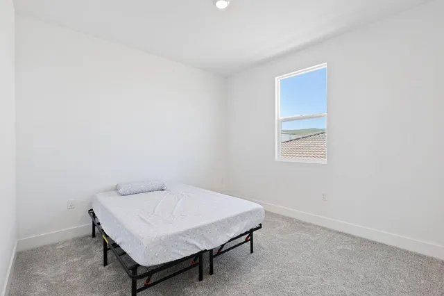 a bedroom with a bed and cabinets