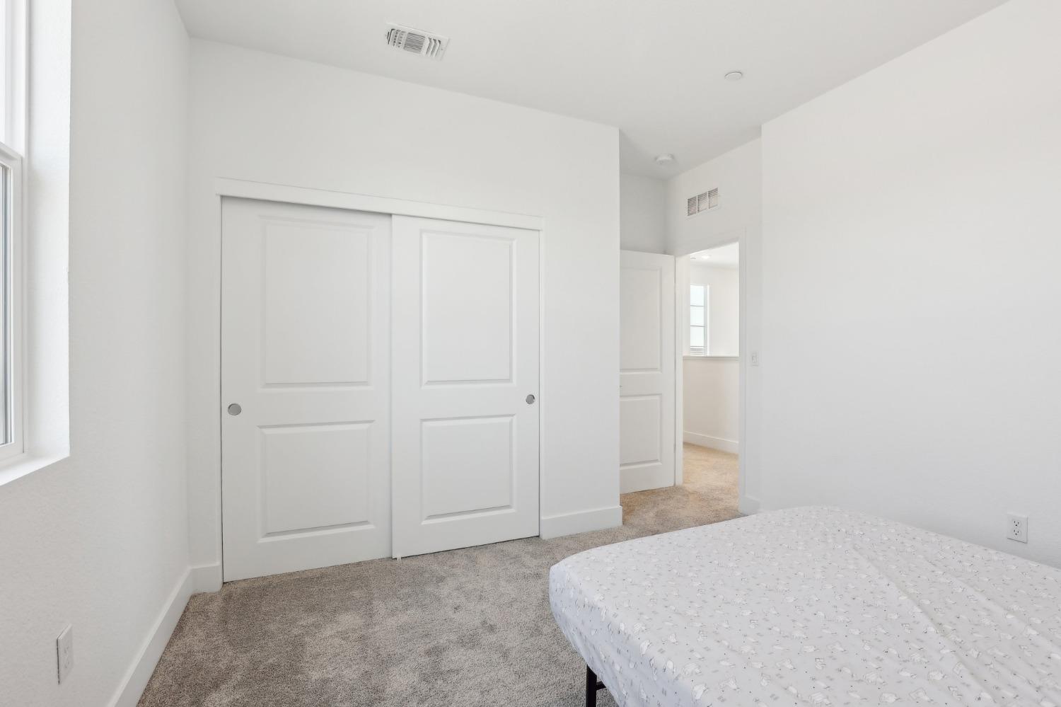 2200 Stagecoach Road Patterson, CA 95363 - Photo 26 of 35 a bedroom with a bed and cabinets