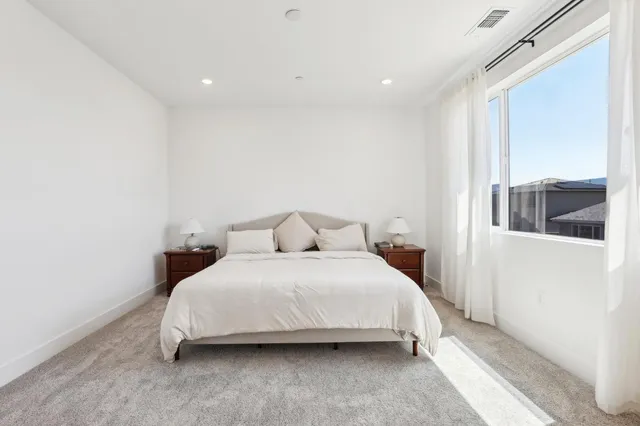 a bedroom with a large bed and a window