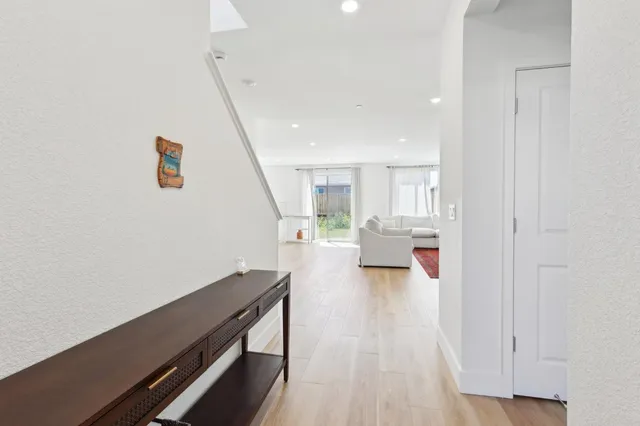 a view of front door with furniture and wooden floor