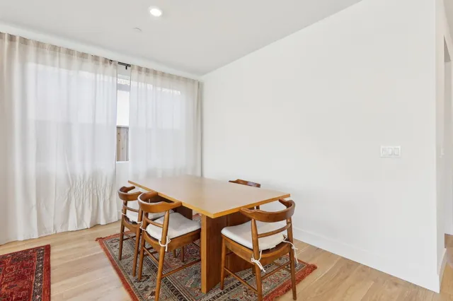 a view of a room with furniture and wooden floor