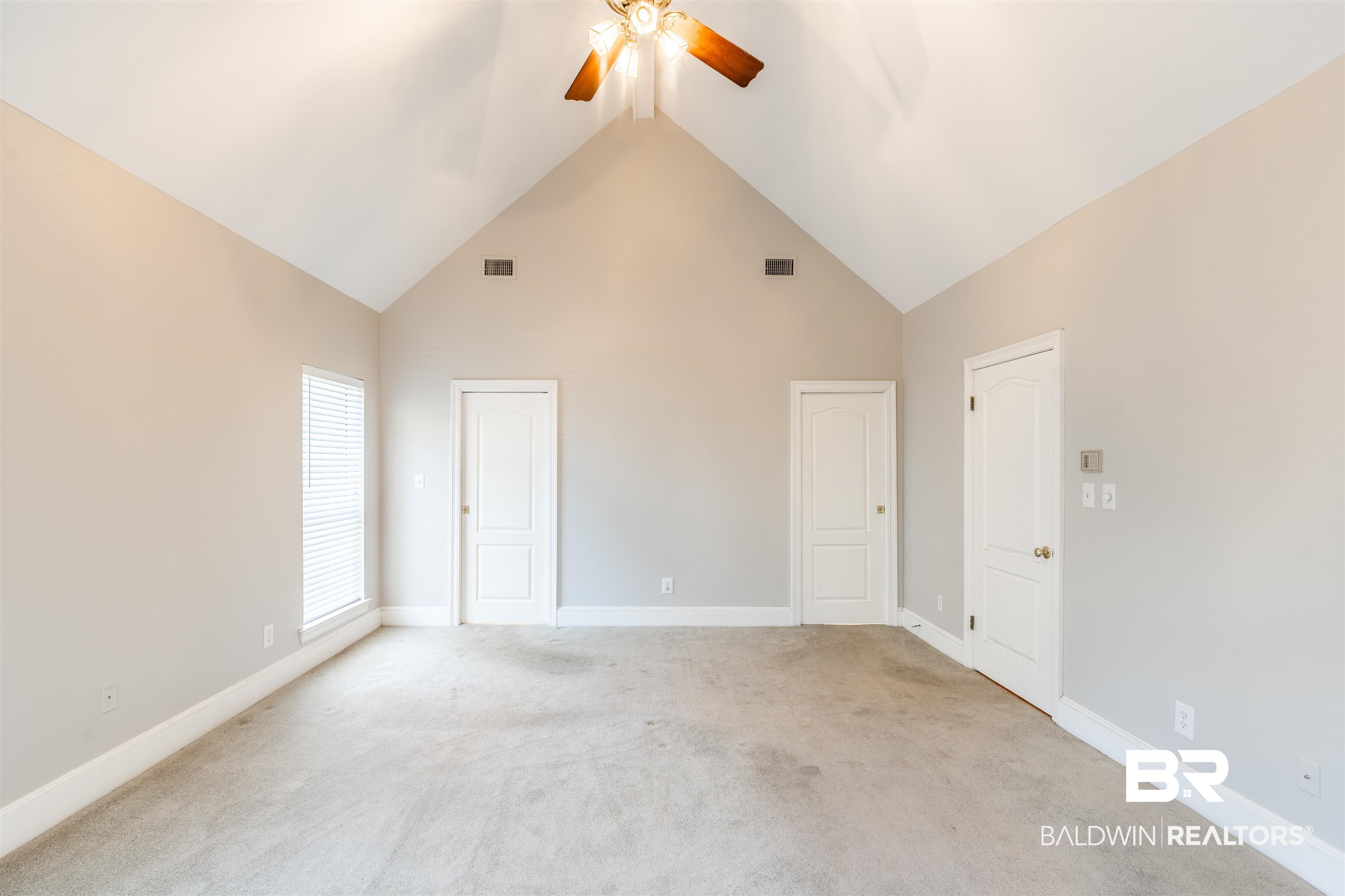 3821 St Andrews Loop East Mobile, AL 36693 - Photo 27 of 41 Carpeted empty room featuring ceiling fan and high vaulted ceiling