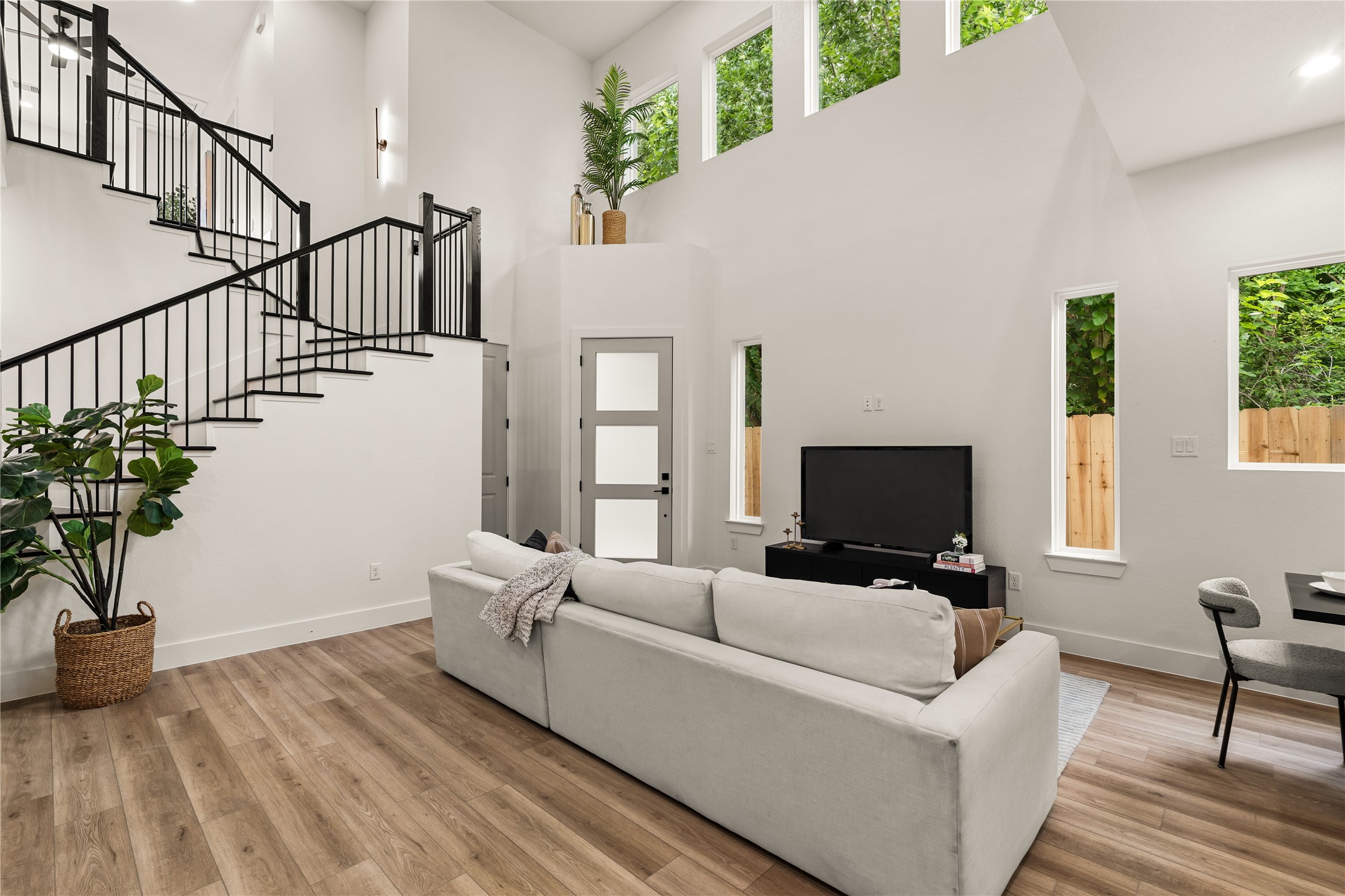 3539 Mainer Street, Unit B Houston, TX 77021 - Photo 3 of 29 Rear of the living room — tall windows, backyard views, and two stories of natural light