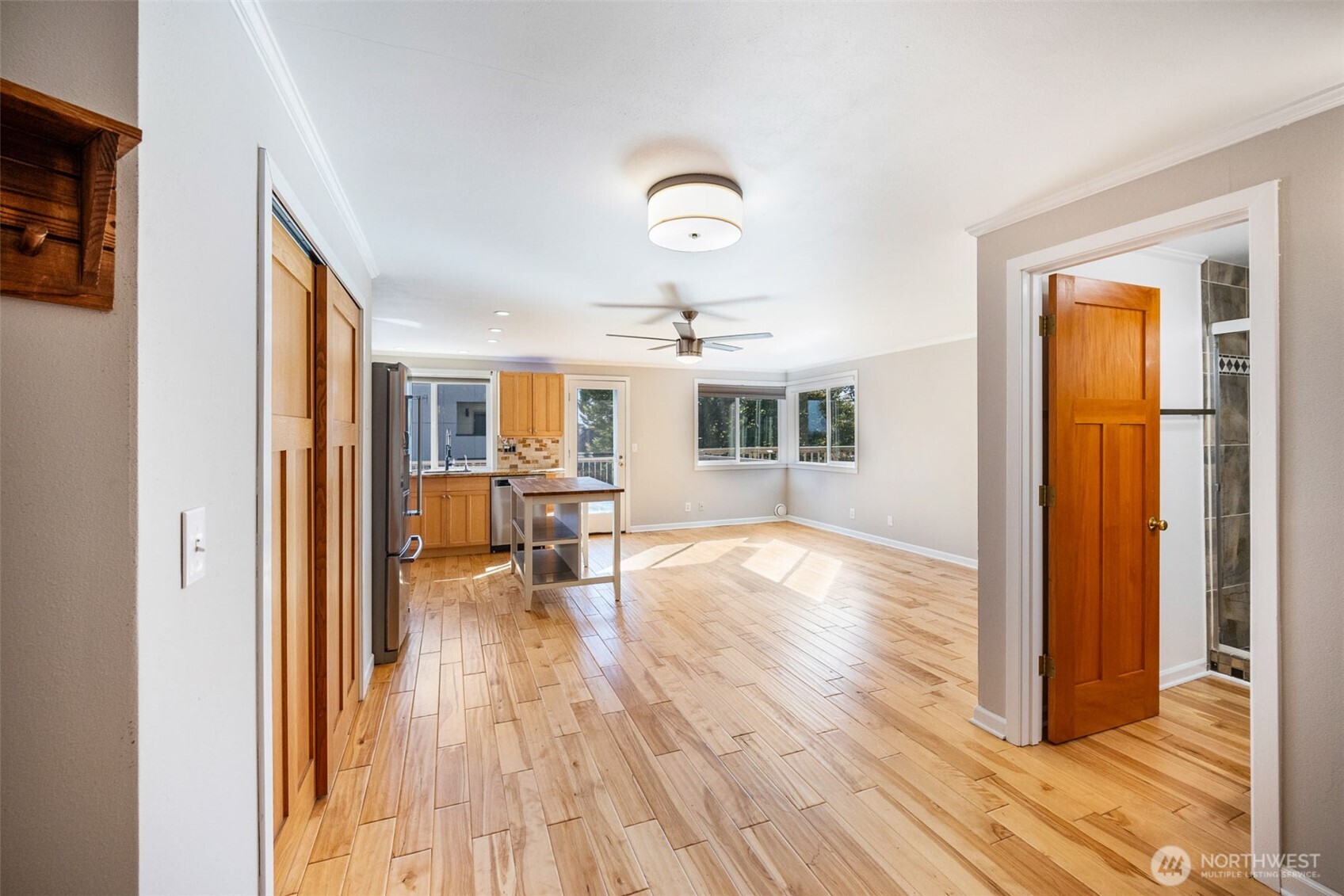 2400 East Howell Street, Unit G Seattle, WA 98122 - Photo 14 of 31 a view of a livingroom with wooden floor and a ceiling fan