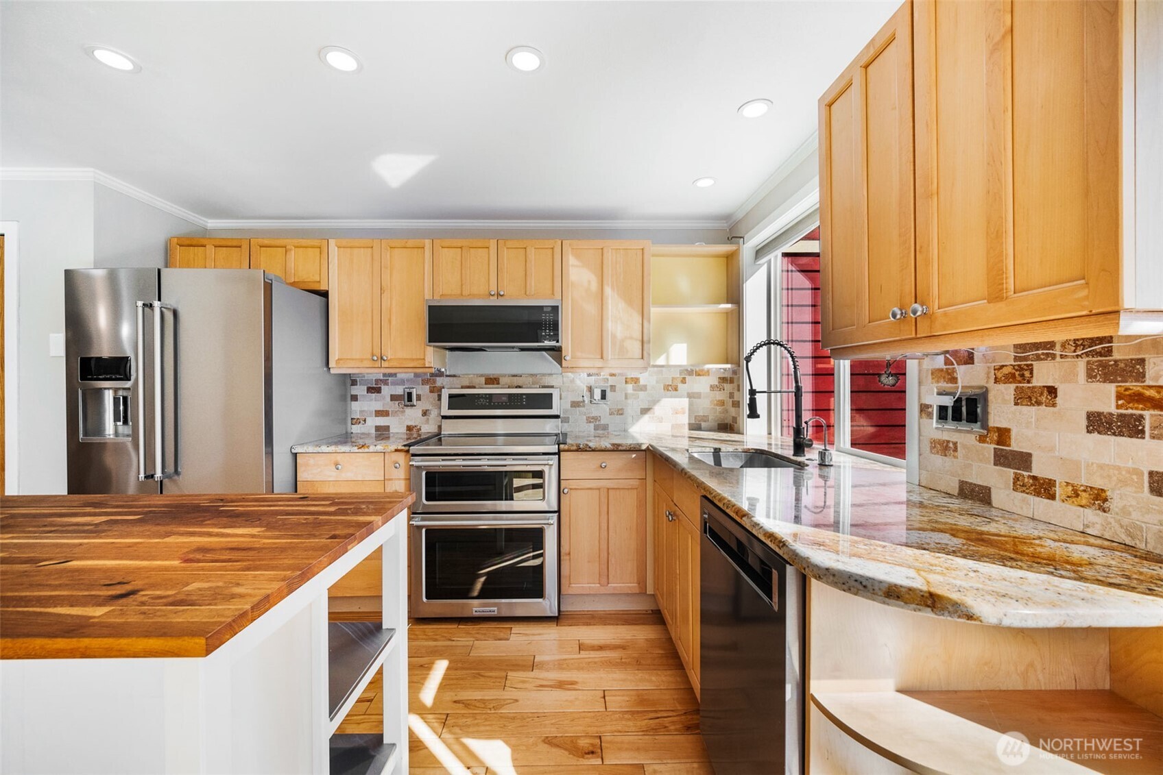 2400 East Howell Street, Unit G Seattle, WA 98122 - Photo 17 of 31 a kitchen with stainless steel appliances a stove sink and microwave