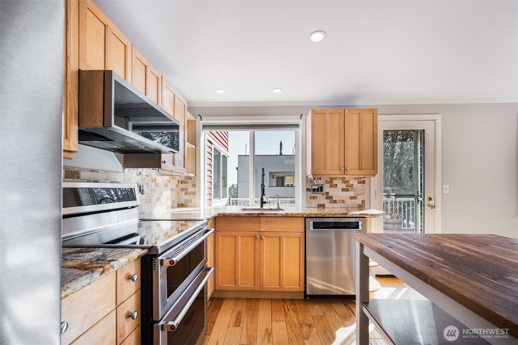 2400 East Howell Street, Unit G Seattle, WA 98122 - Photo 18 of 31 a kitchen with stainless steel appliances granite countertop a stove and a sink