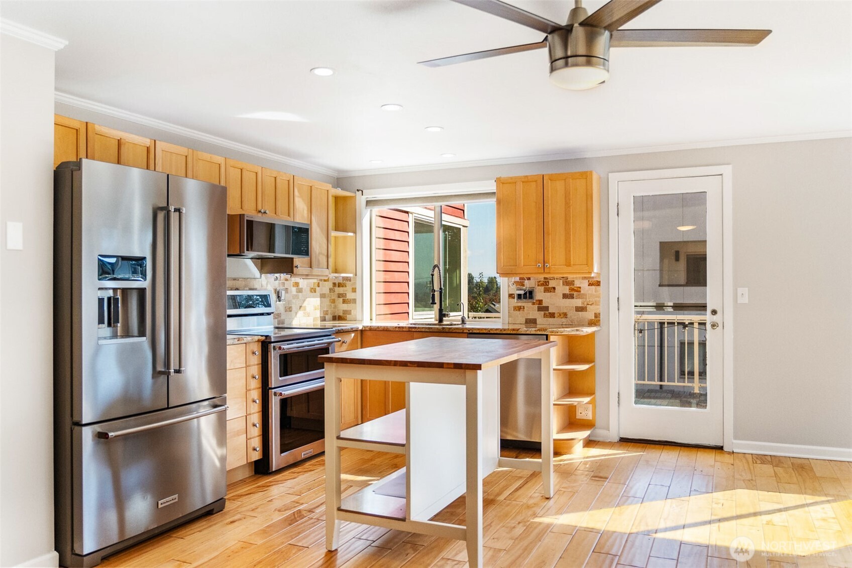 2400 East Howell Street, Unit G Seattle, WA 98122 - Photo 7 of 31 a kitchen with stainless steel appliances a refrigerator a stove a sink and a refrigerator with wooden floor