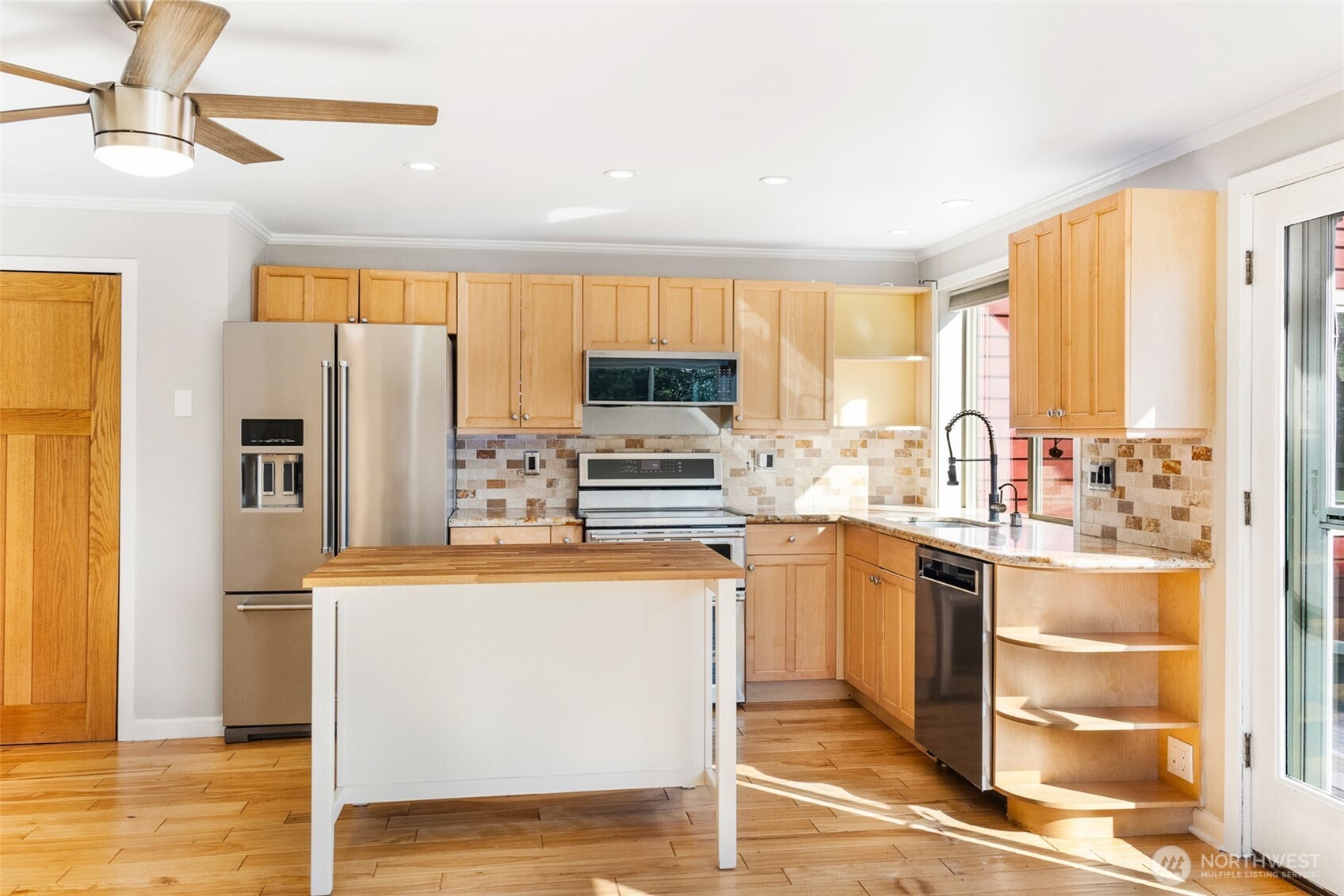2400 East Howell Street, Unit G Seattle, WA 98122 - Photo 9 of 31 a kitchen with stainless steel appliances granite countertop a refrigerator and a stove top oven