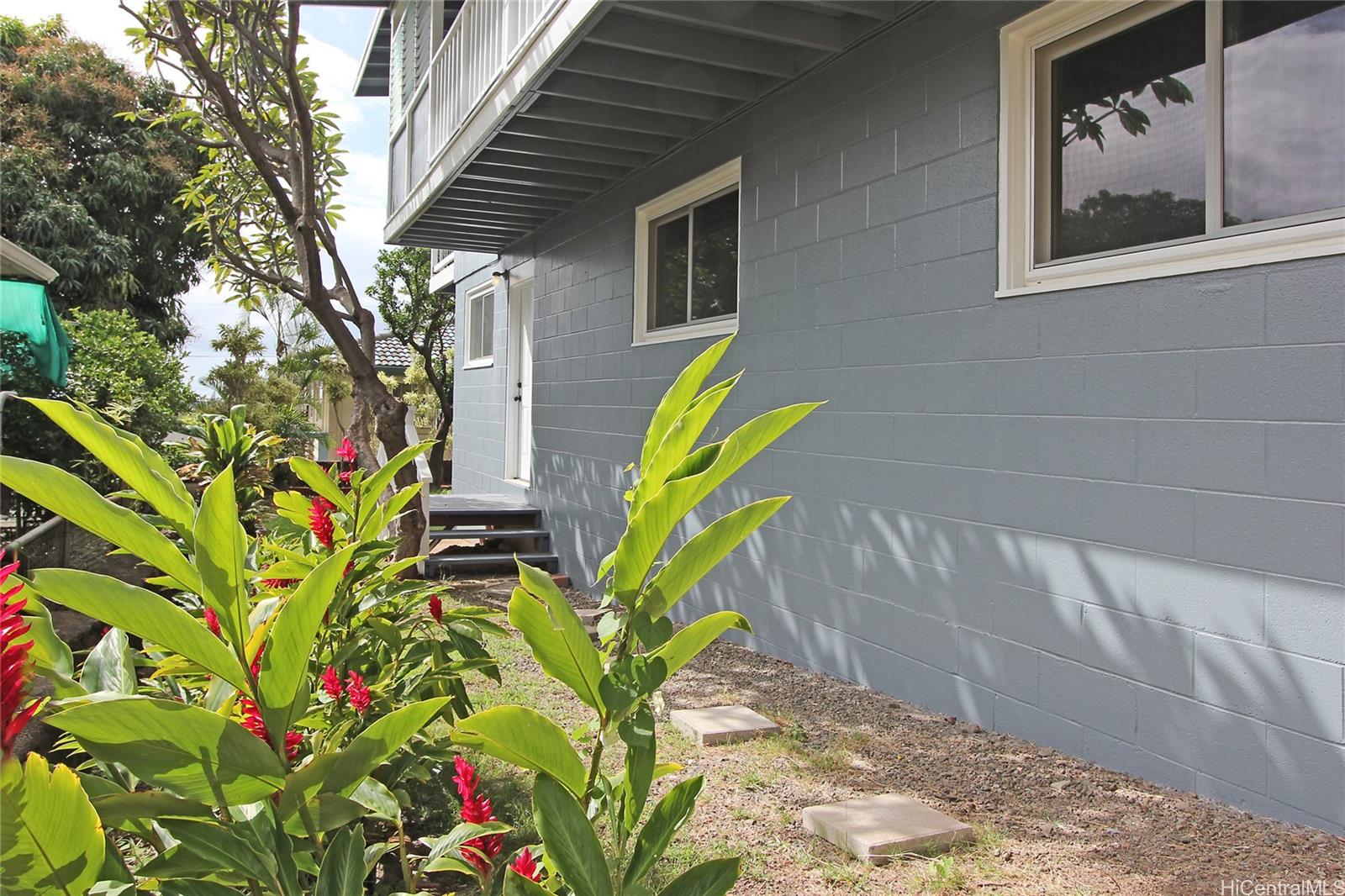 3647 Aliamanu Street Honolulu, HI 96818 - Photo 13 of 16 a view of a house with a flower in a garden