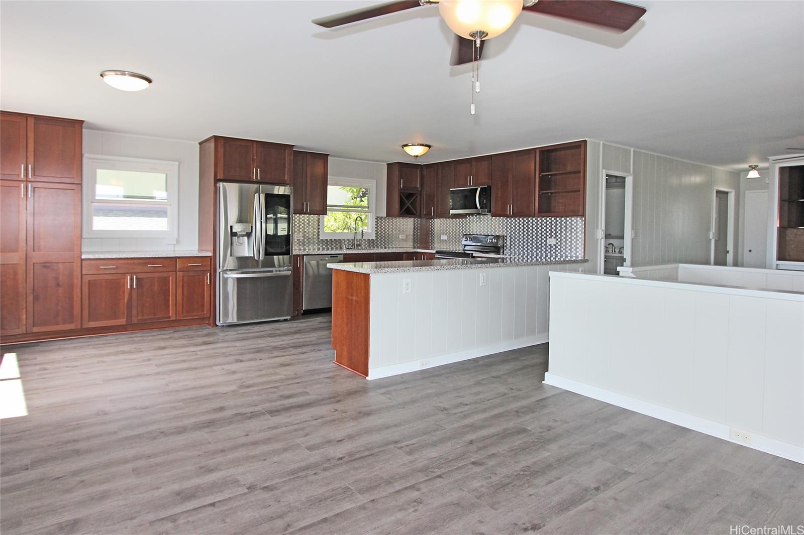 3647 Aliamanu Street Honolulu, HI 96818 - Photo 2 of 16 a kitchen with stainless steel appliances kitchen island granite countertop a stove refrigerator and cabinets