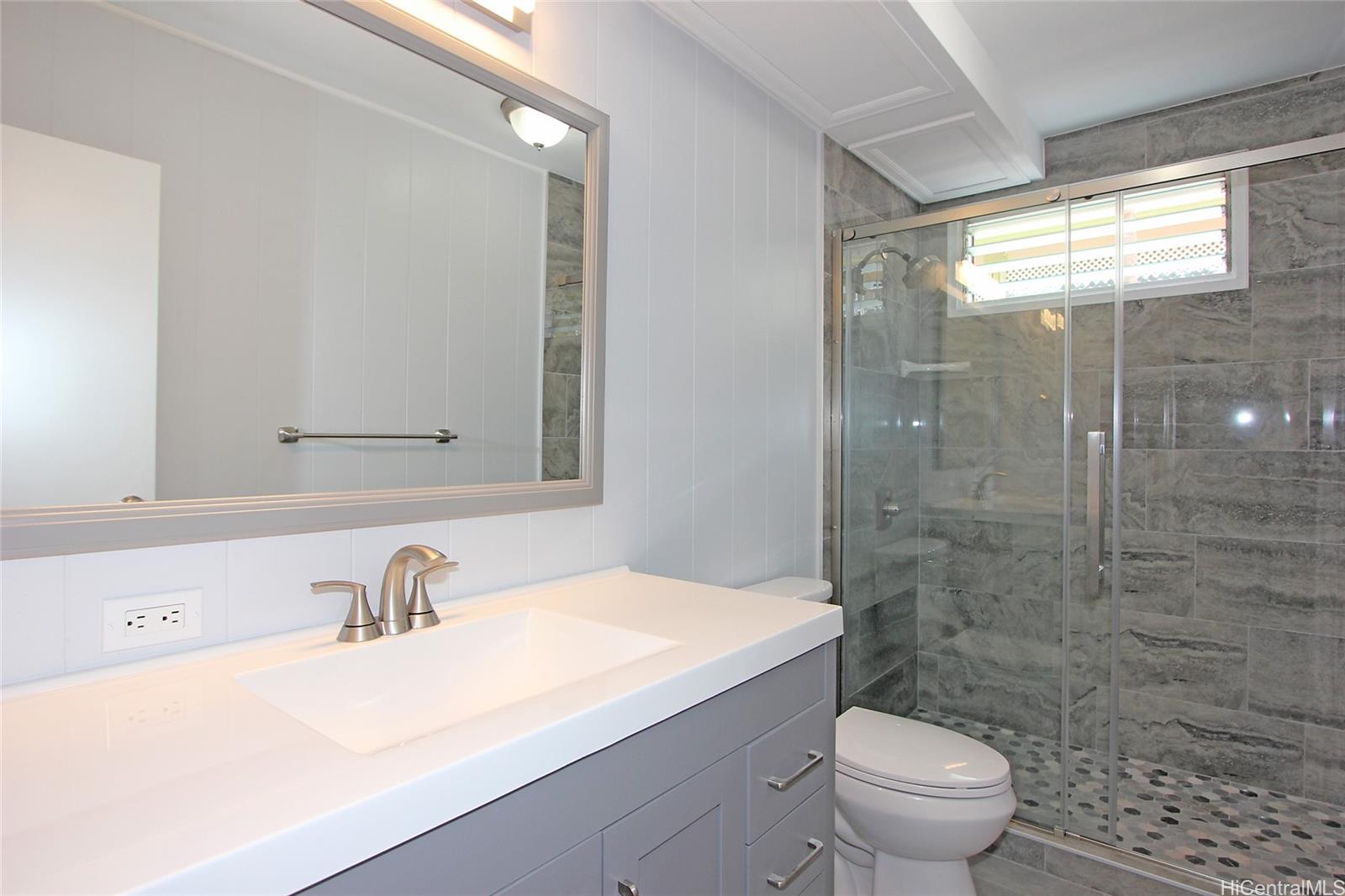 3647 Aliamanu Street Honolulu, HI 96818 - Photo 9 of 16 a bathroom with a sink a toilet and shower