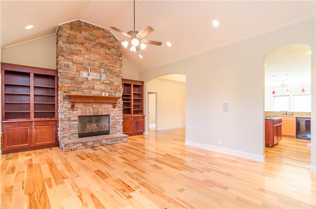3443 Thompson Road Springfield, TN 37172 - Photo 4 of 20 This spacious living room has beautiful hardwood flooring and a striking stacked-stone wood-burning fireplace with a gas starter. It is flanked bywonderful built-in bookcases. It also has TV mounting hardware so it's ready for your flat-screen!