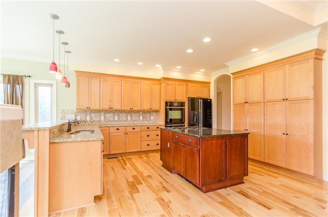 3443 Thompson Road Springfield, TN 37172 - Photo 5 of 20 Wow, what a gorgeous kitchen. Features include granite counters, a gas range, double ovens, a breakfast bar and large island. It also provides a great view of the farmland behind the home.