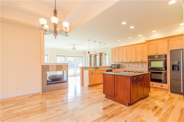 3443 Thompson Road Springfield, TN 37172 - Photo 6 of 20 Adjacent to the kitchen is a large eat-in dining area with a tray ceiling and gas see-thru fireplace that is shared with the sunroom.