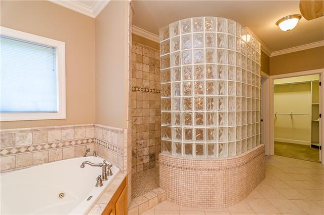 3443 Thompson Road Springfield, TN 37172 - Photo 10 of 20 Who wouldn't love this large corner jetted tub and large tile and glass block shower. There is also another large walk-in closet with built-in organizational system.