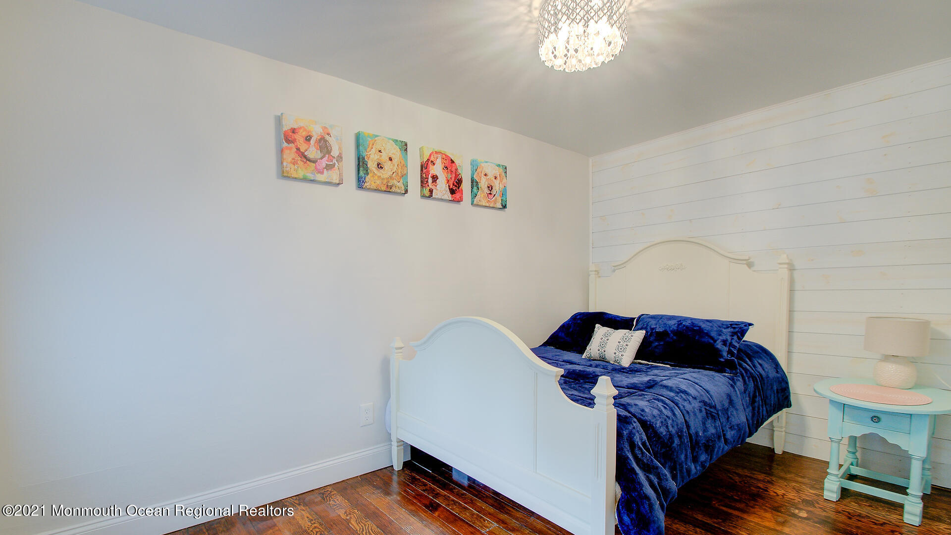10 Cherry Tree Farm Road Middletown, NJ 07748 - Photo 36 of 43 a bedroom with a bed and a chandelier