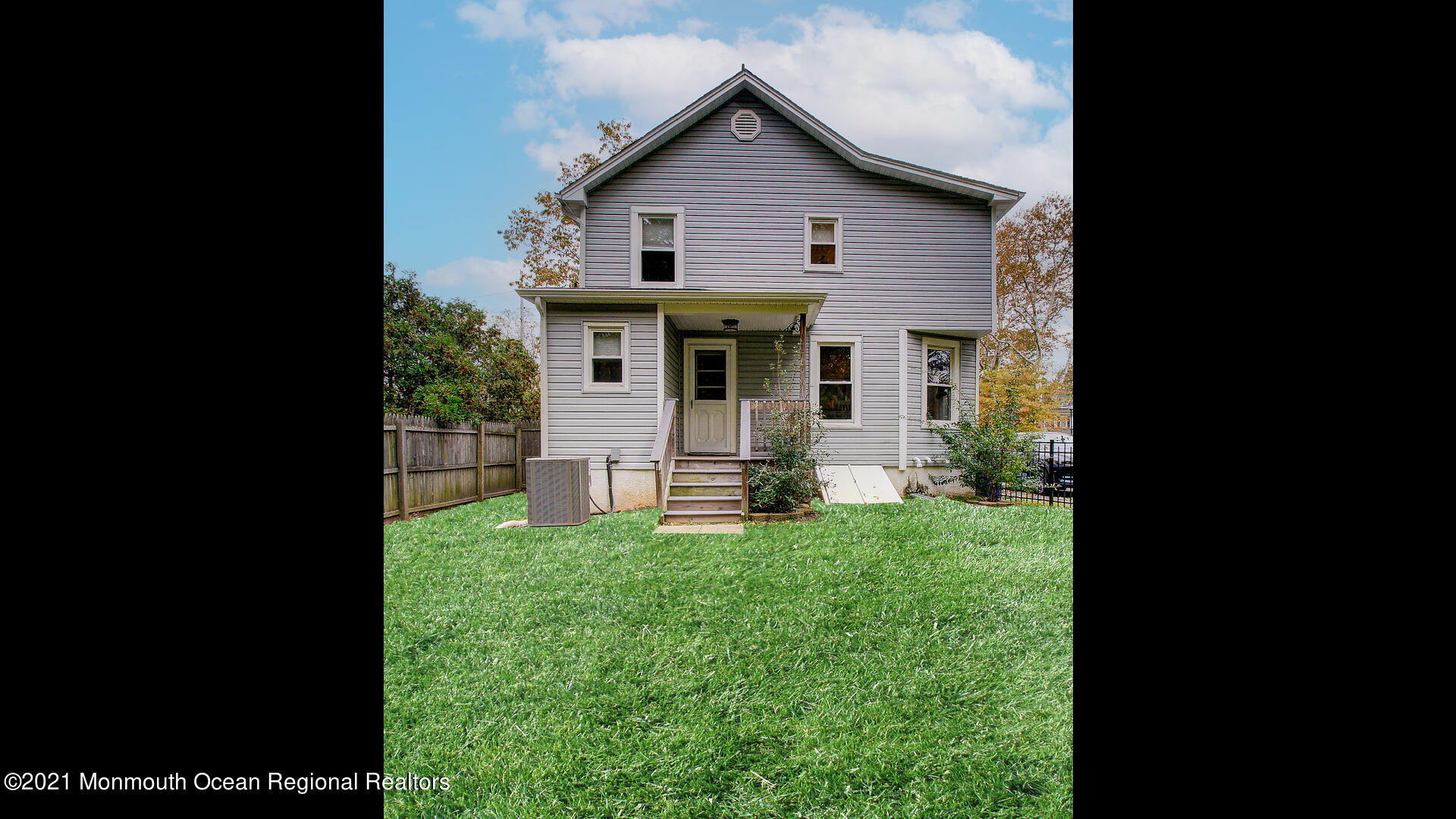 10 Cherry Tree Farm Road Middletown, NJ 07748 - Photo 43 of 43 a view of a house with a small yard and wooden fence