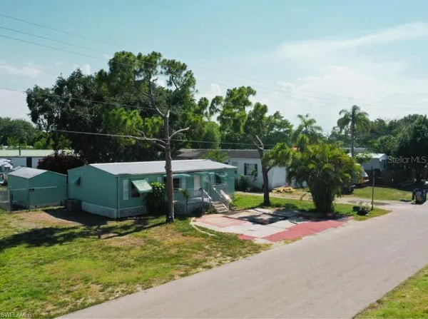 a view of street with a house in the background